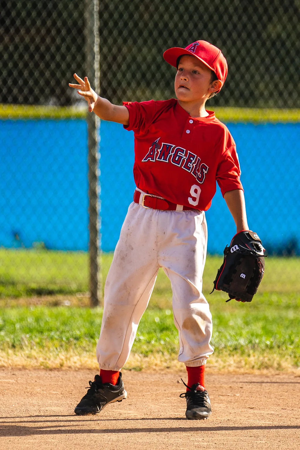 Little league Angels player making a throw in Southern California