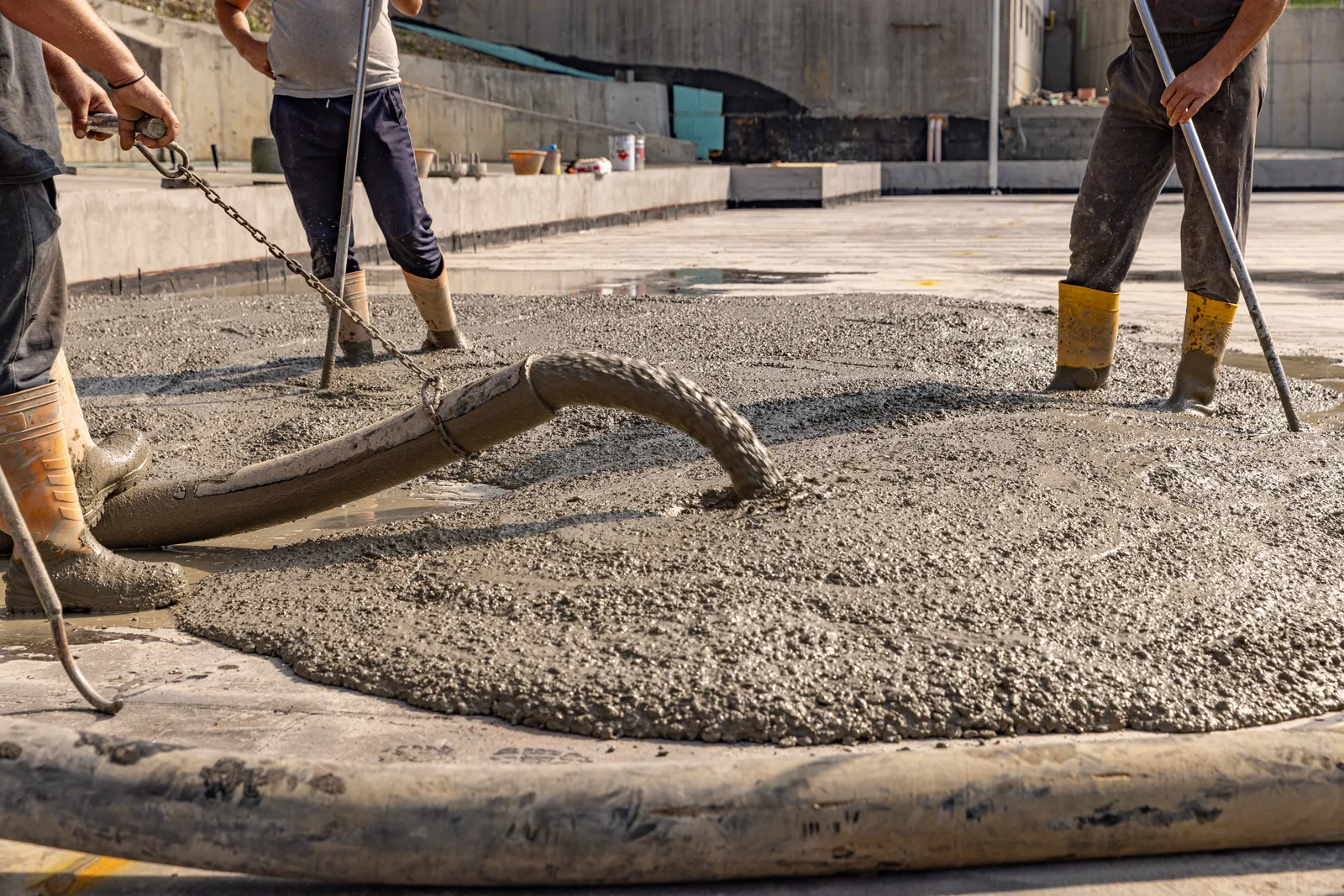 Construction worker pouring wet concrete on a residential project in the Inland Empire