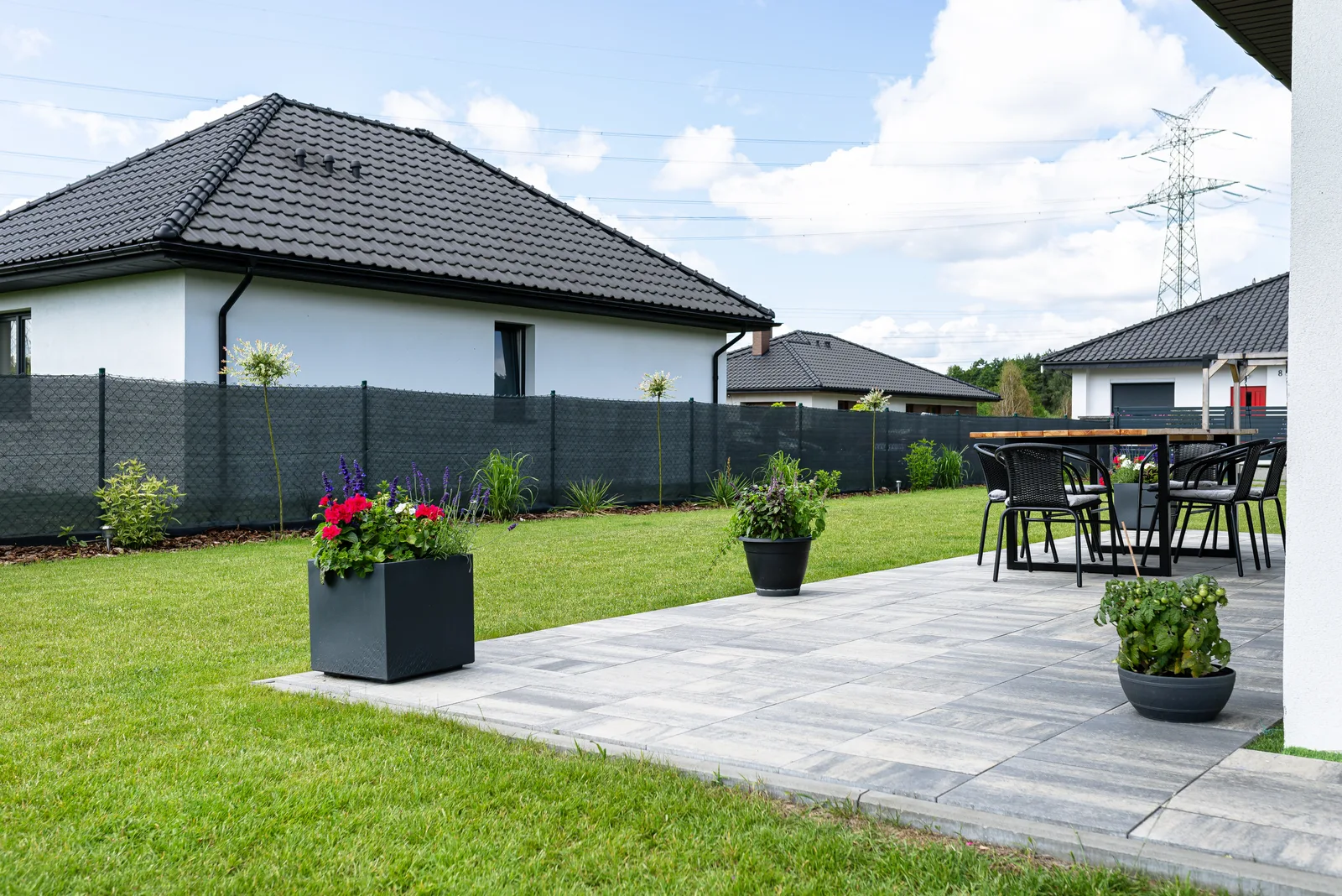 Stamped concrete patio with potted plants and garden in Yucaipa backyard